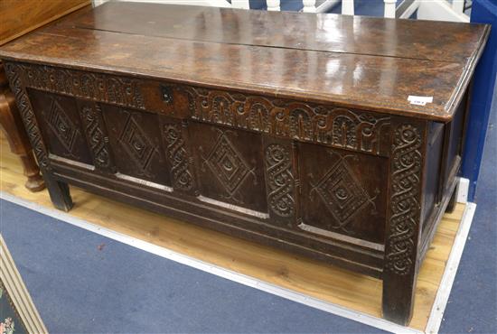 An 18th century later carved oak coffer, W.150cm